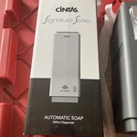New Cintas Signature Series Automatic Soap Dispenser Dark Grey With White Cover. Fixed Price $35.00.