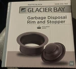 Glacier Bay Garbage Disposal Rim And Stopper Stainless Steel Matte Black. Fixed Price $12.99.